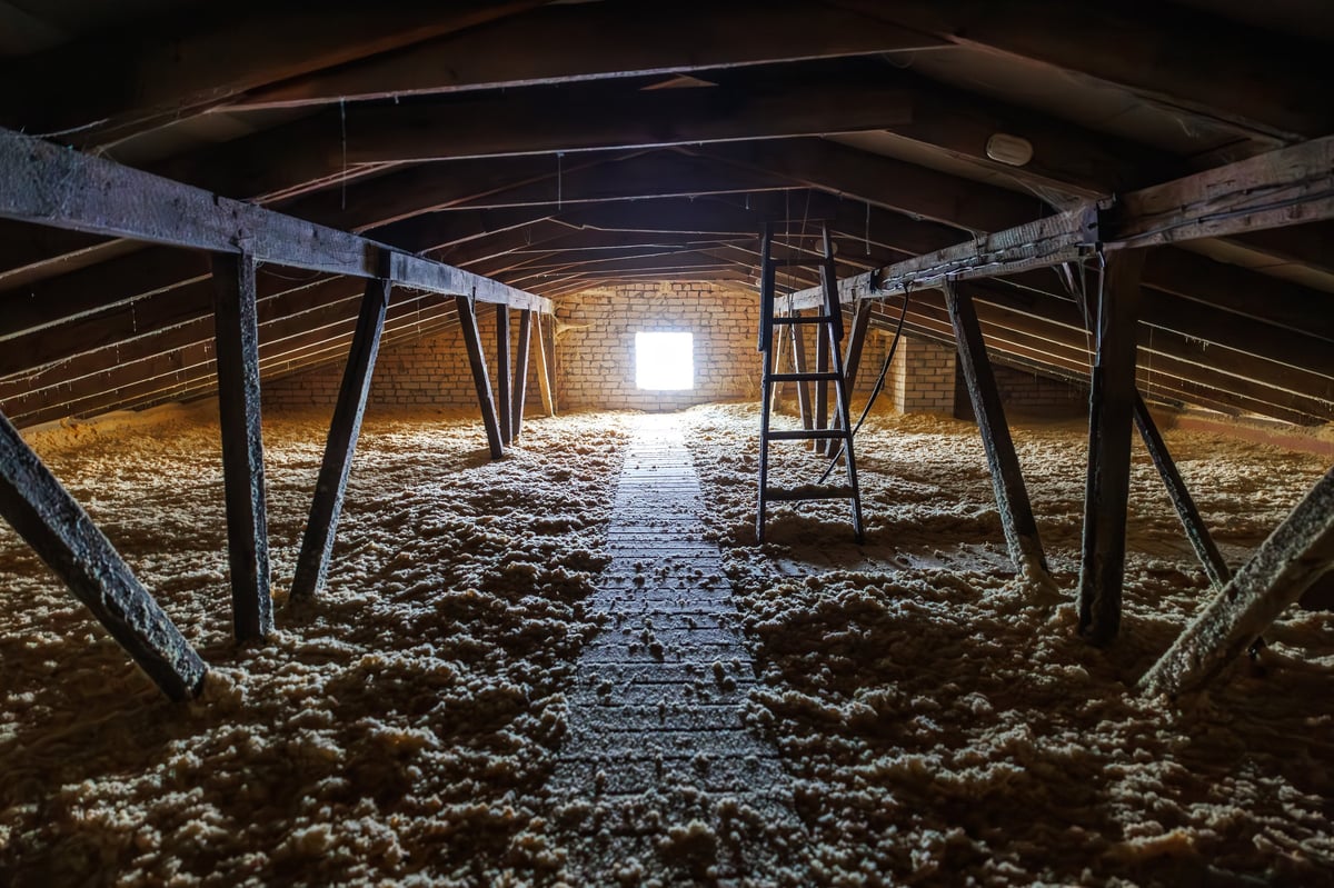 Attic with blown-in insulation and plank walkway